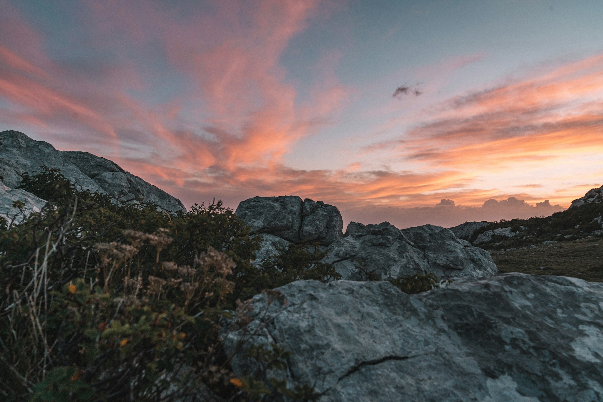 Dramatic sunset sky over a rocky mountain ridge landscape