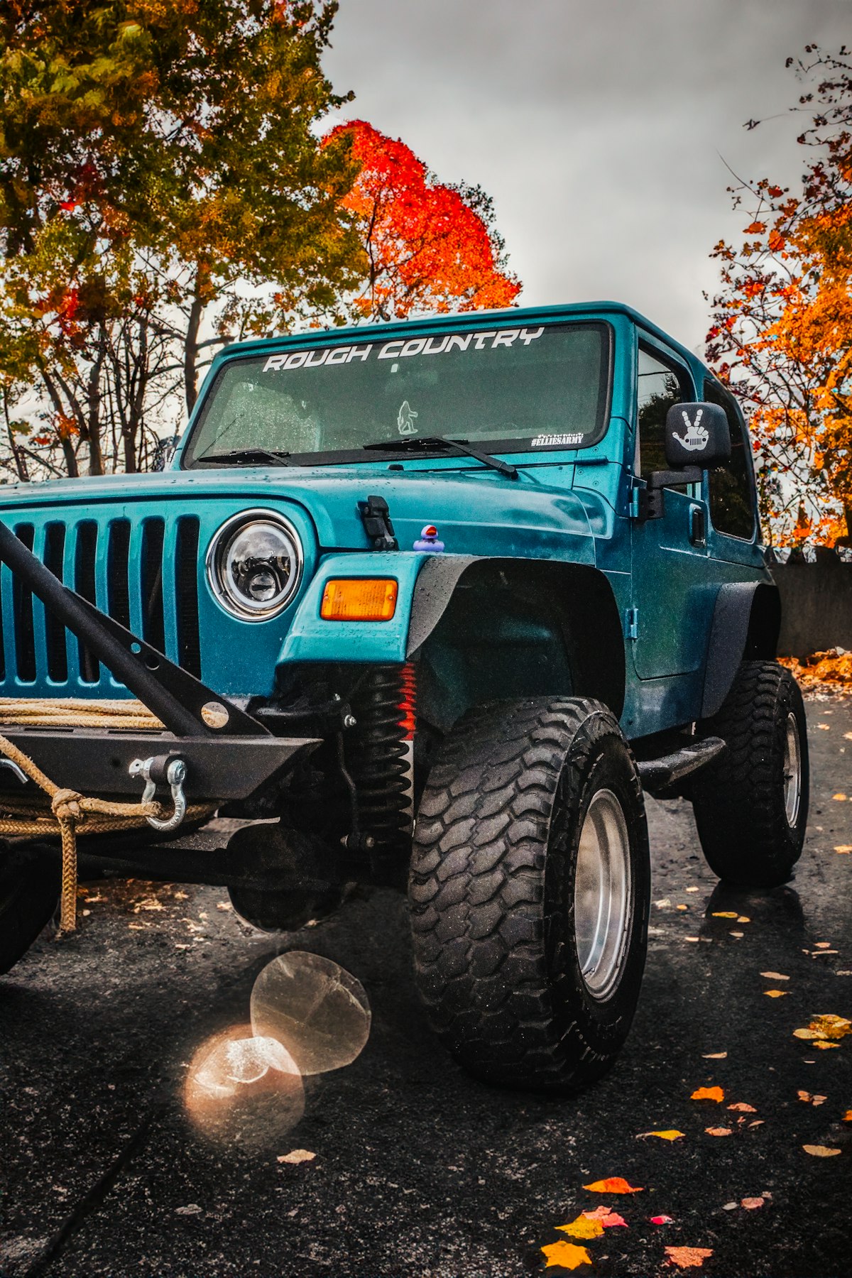 Turquoise off-road Jeep parked outdoors