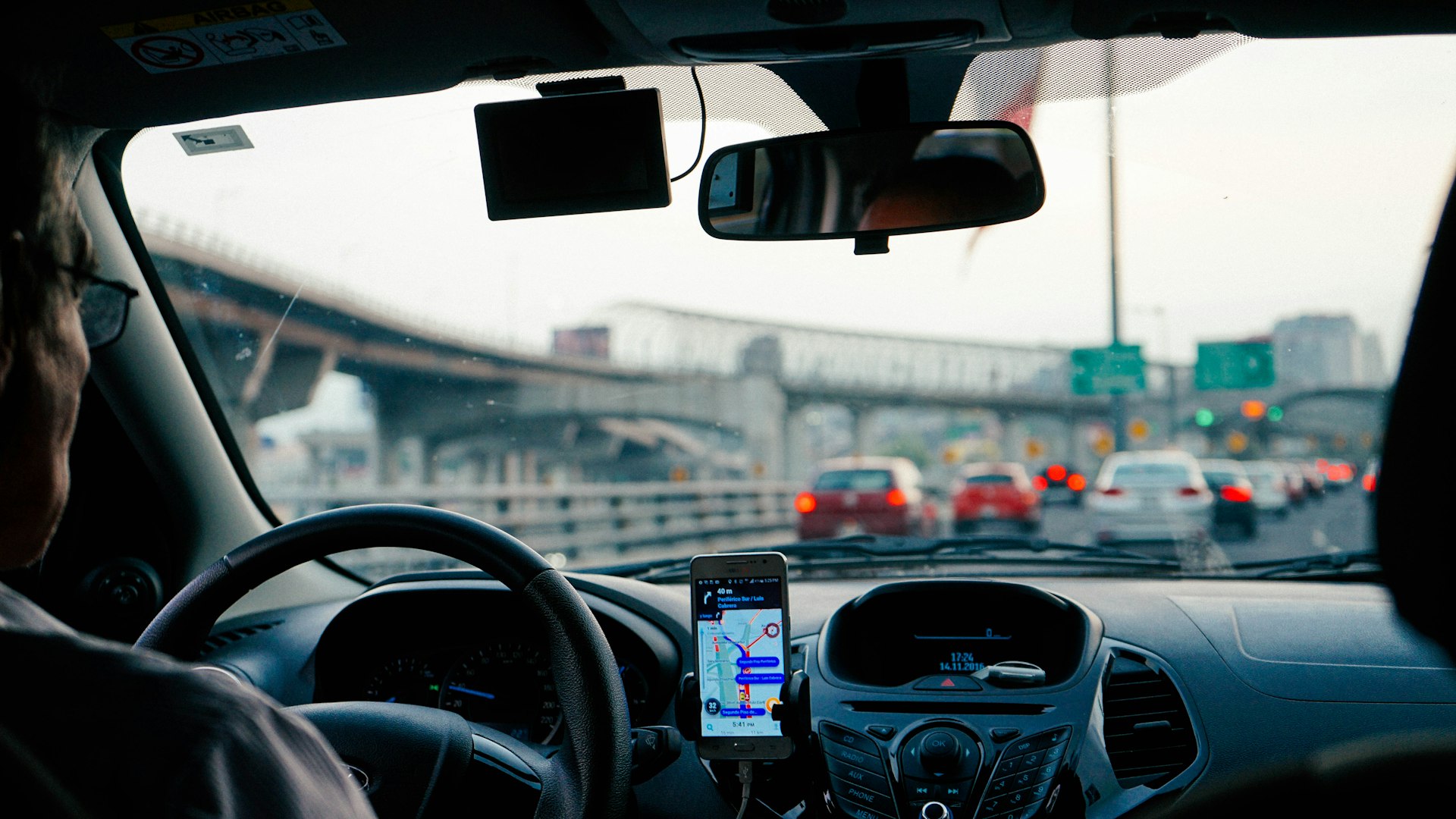 Guest driving with a GPS navigation unit mounted on the dashboard